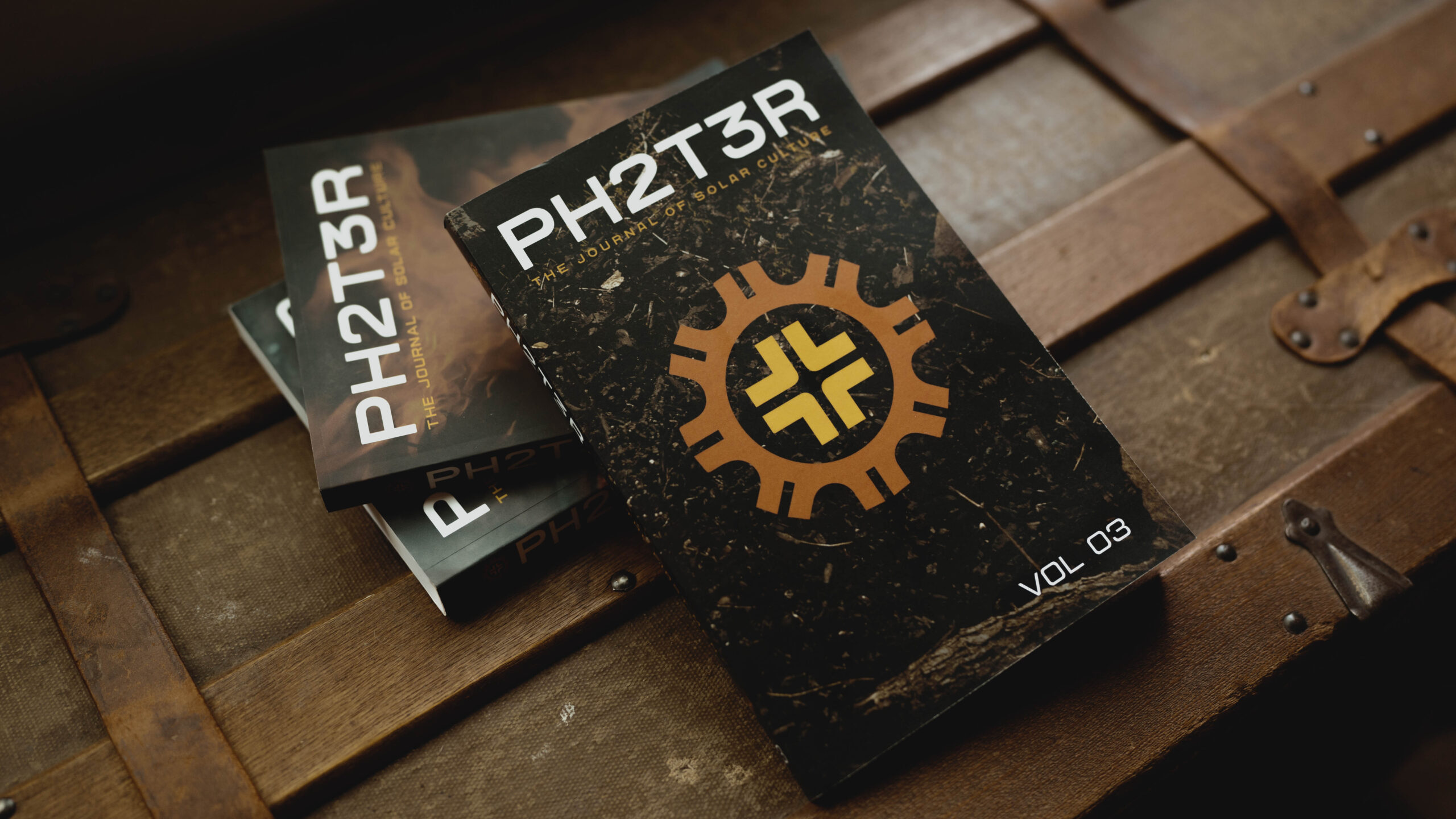 PH2T3R books - all three volumes photographed on an antique trunk