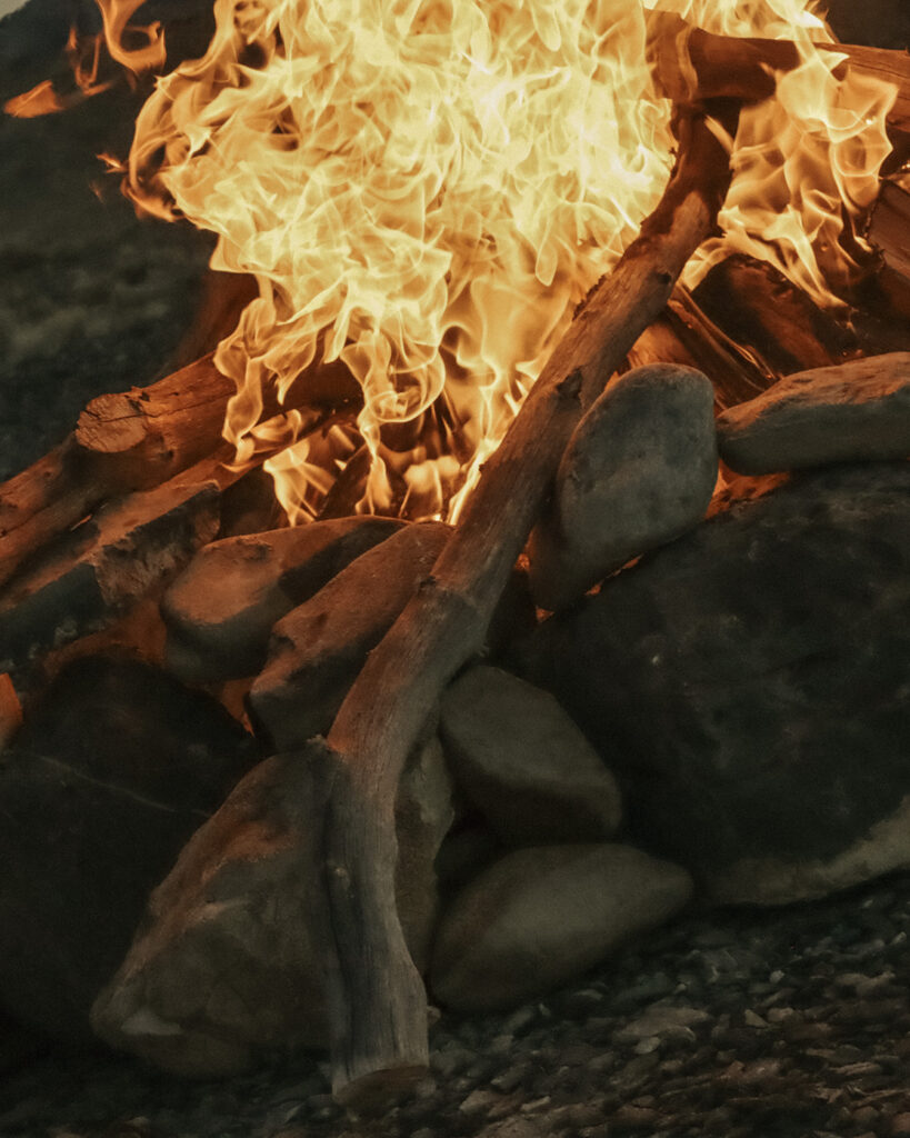 Close-up of a flaming campfire with burning logs